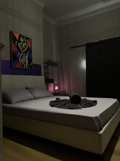 Private room with a king bed and a towel arranged on the linen